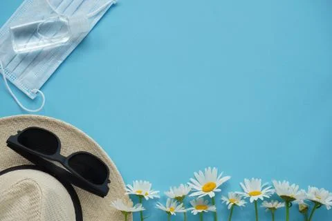 Summer layout with straw hat, daisies and sunglasses, mask, thermometer and s Stock Photos