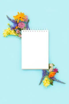 Summer minimal layout made with white blank spiral notebook and colorful flow Stock Photos