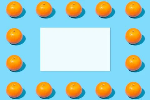 Summer mockup - empty sheet of paper on a blue background with tangerines Stock Photos
