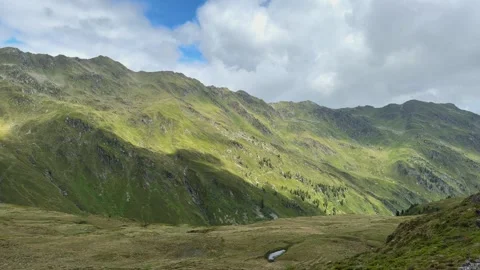 Summer Mountain Landscape in Austrian Alps with Verdant Slopes and Cloudy Sky Stock Footage 336196197