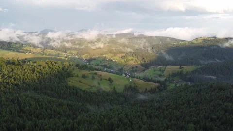 Summer mountain landscape with drifting clouds and forested hills Stock Footage 338104673