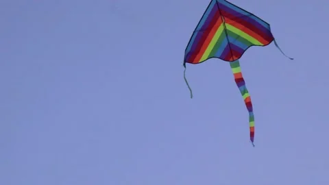 Summer multi-colored kite flying through the sky Stock Footage 134259132