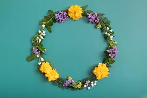 Summer or spring composition on green background. Purple and yellow flowers.. Stock Photos