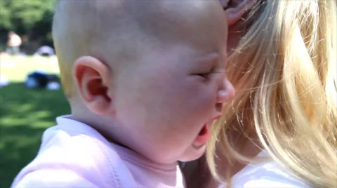 Summer in a park or forest, a loving mother embraces her tiny baby. High quality 스톡 동영상 32961045