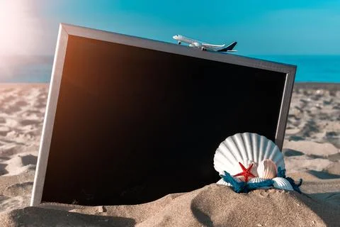 Summer pattern background. Starfish, seashells, toy plane and globe near blac Stock Photos