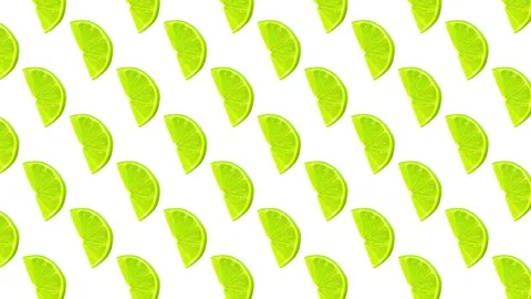 Summer pattern made with green lemon slice on bright light blue background Stock Footage 273877945