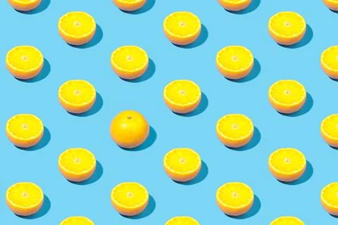 Summer pattern of yellow lemon slice on bright blue background. Minimal summe Stock Photos