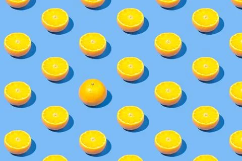 Summer pattern of yellow lemon slice on bright blue background. Minimal summe Stock Photos