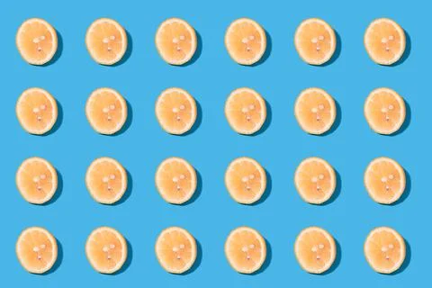 Summer pattern of yellow lemon slices on light-mint background. Stock Photos