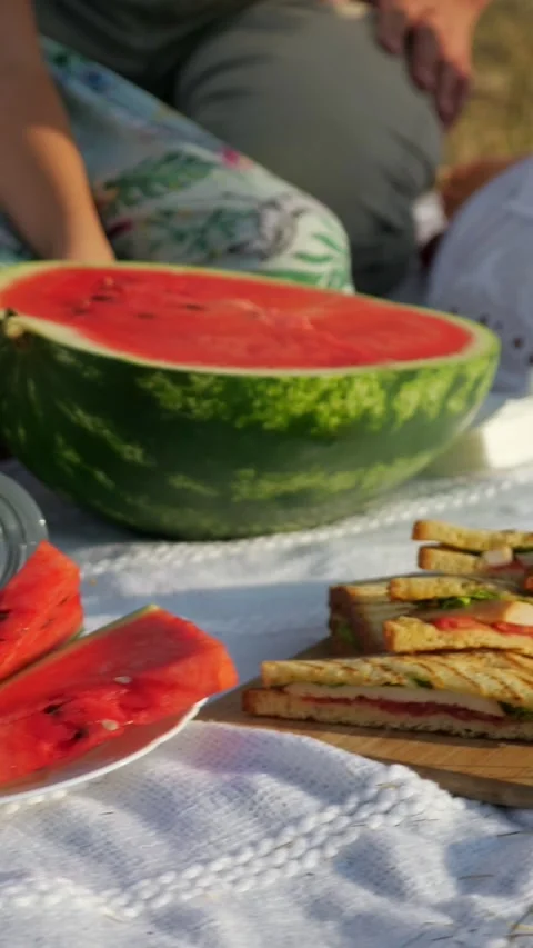 Summer picnic setting on a white blanket with fresh watermelon slices Stock-Footage 341429214