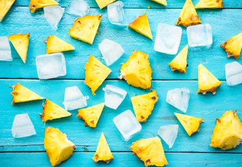 The summer pineapple is slice for eat with cold ice on blue wooden background Stock Photos