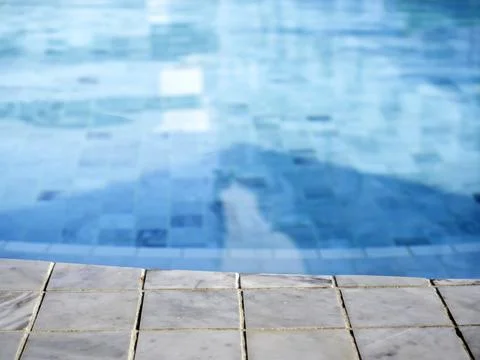 Summer pool background. Empty space on the pool edge, marble stone tiles and  Stock Photos