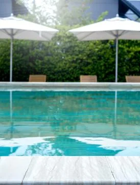 Summer pool background. Empty space on the pool edge, marble stone tiles an.. Stock Photos
