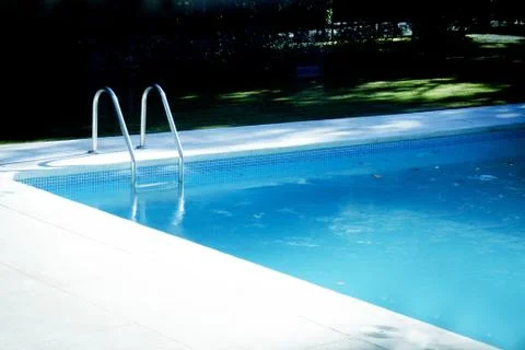 Summer pool surrounded by grass Foto stock