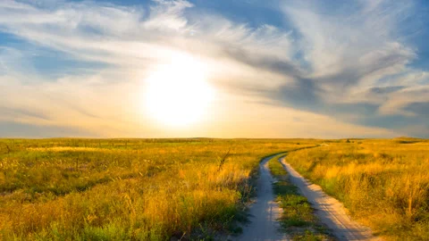 Summer prairie with ground road at the evening time lapse scene Stock Footage 243374476