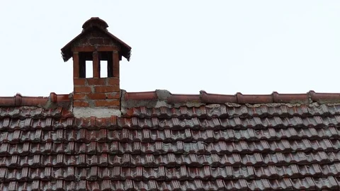 Summer rain falling on the red tile roof and chimney Stock Footage 83525175