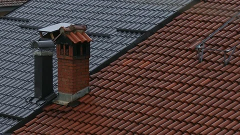 Summer rain falling on the red tile and metal roofs Stock Footage 83525411