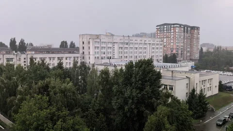 Summer rain over urban landscape with green trees and buildings horizontal .. Video stock 316601547