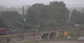 Summer Rain Storm Container Cargo Train Passing Aerial View Freight Shipping Day 4k or 4k+ Resolution