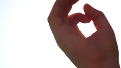 Summer rays of sunlight shine through child’s hand, close-up  스톡 동영상 76930323