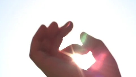 Summer rays of sunlight shine through child’s hand, close-up  스톡 동영상 76930326