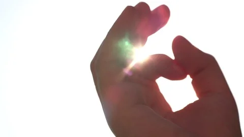 Summer rays of sunlight shine through child’s hand, close-up  스톡 동영상 76930328