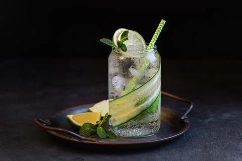 Summer refreshing cocktail with lime and cucumber, selective focus Stock Photos