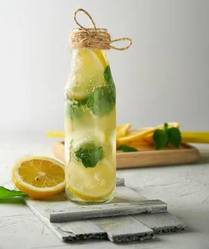 Summer refreshing drink lemonade with lemons, mint leaves, lime in a glass .. Stock Photos