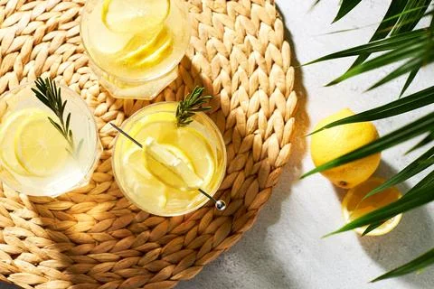 Summer refreshing drinks with fresh lemon slices and rosemary sprigs. Alcoholic Stock Photos