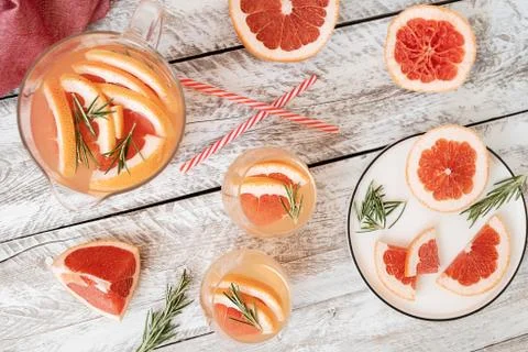 Summer refreshing lemonade with grapefruit and rosemary in a glass jug . Stock Photos
