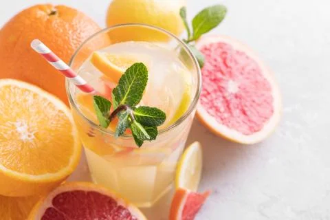 Summer refreshing lemonade with mint on a light background. A glass of citrus 写真素材