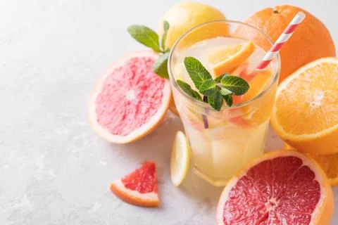 Summer refreshing lemonade with mint on a light background. A glass of citrus Stock Photos