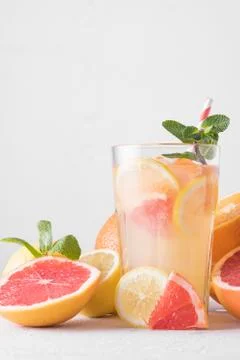 Summer refreshing lemonade with mint on a light background. A glass of citrus Stock Photos