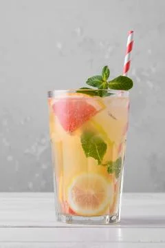 Summer refreshing lemonade with mint on a light background. A glass of citrus Stock Photos