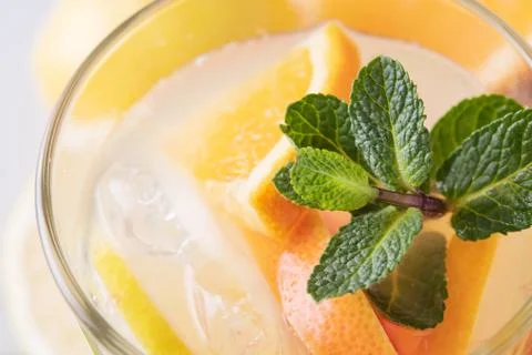 Summer refreshing lemonade with mint on a light background. A glass of citrus Stock Photos