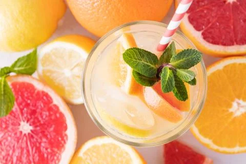 Summer refreshing lemonade with mint on a light background. A glass of citrus Stock Photos