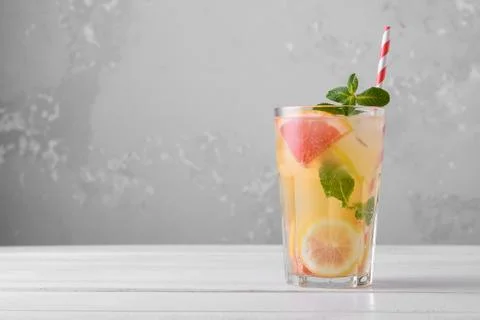 Summer refreshing lemonade with mint on a light background. A glass of citrus Photos