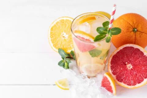 Summer refreshing lemonade with mint on a light background. A glass of citrus Stock Photos