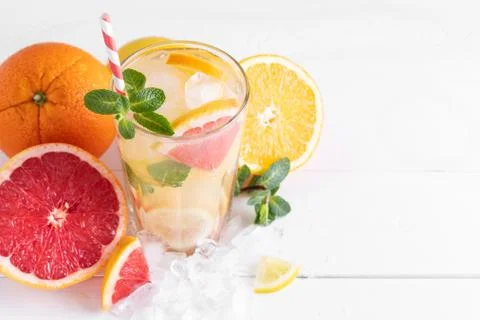 Summer refreshing lemonade with mint on a light background. A glass of citrus Stock Photos