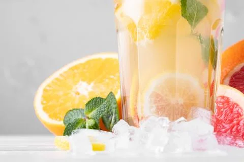 Summer refreshing lemonade with mint on a light background. A glass of citrus Stock Photos