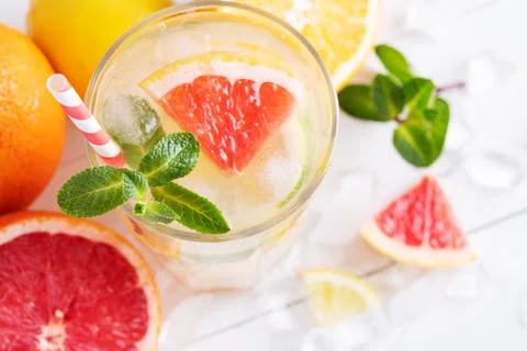 Summer refreshing lemonade with mint on a light background. A glass of citrus Stock Photos