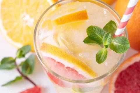 Summer refreshing lemonade with mint on a light background. A glass of citrus Stock Photos