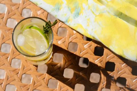 Summer refreshing lemonade on wicker bench, above view. Space for text Stock Photos