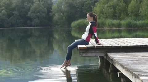 Summer refreshment. Touching water with toes Video stock 66512848