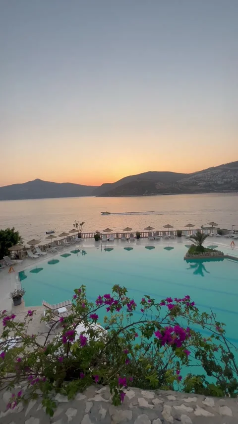 Summer resort with pool in front of the sea by sunset Stock Footage 336974970