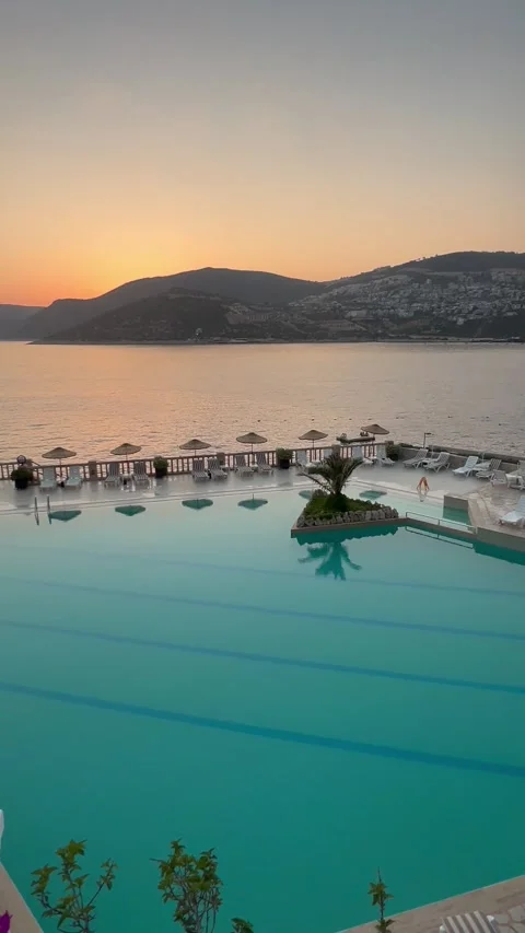 Summer resort with pool in front of the sea by sunset Stock Footage 337137632