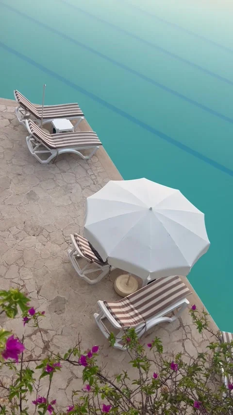 Summer resort with swimming pool and lounge chairs Stock Footage 336974965