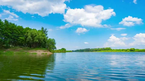 Summer River Flow Under Blue Sky And White Clouds Timelapse Video stock 320513975