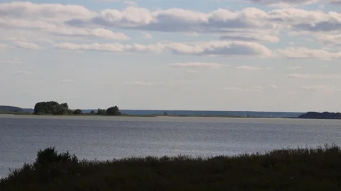Summer, river, grass, sky and clouds Stock Footage 119873319