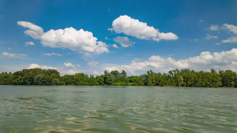 Summer River under Blue Sky with Moving Clouds Timelapse Stock Footage 320329788